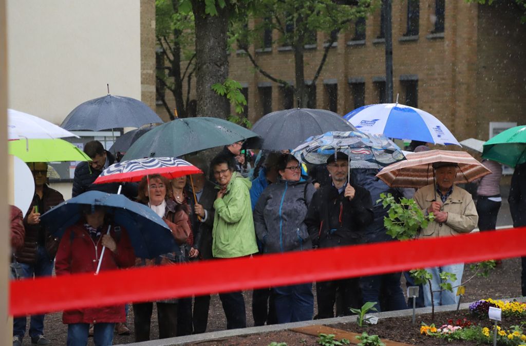 Im strömenden Regen wird der Schaugarten auf dem Kirchplatz eröffnet.