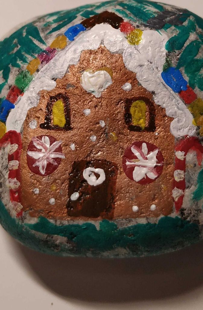 Gerade arbeiten viele Steinemaler an weihnachtlichen Motiven wie diesem Lebkuchenhaus.