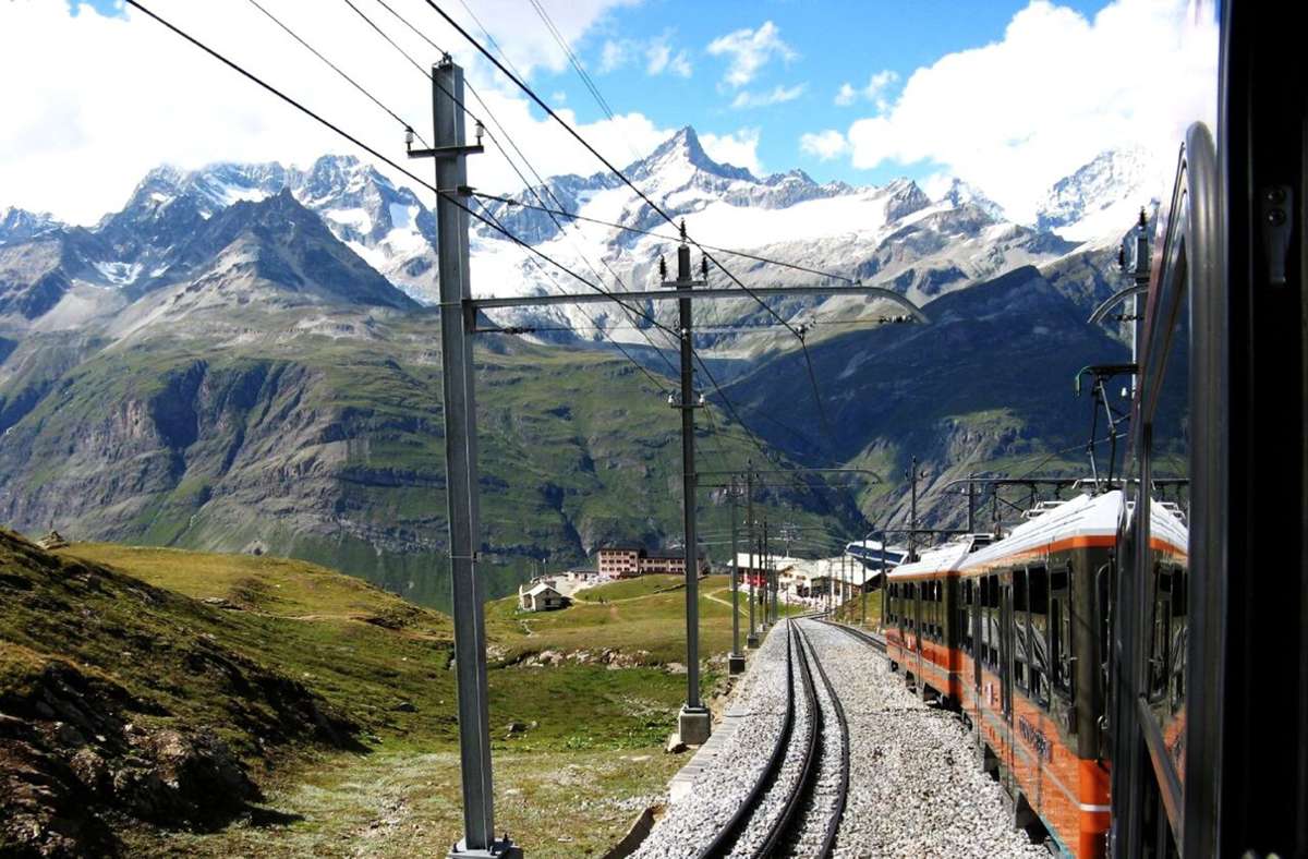 Schweiz: Die Gornergratbahn in Zermatt (zu sehen oberhalb von Riffelberg) ist eine elektrisch betriebene Zahnradbahn auf den Gornergrat in der Monte-Rosa-Region in der Schweiz und ist hinter der Jungfraubahn die zweithöchste Bergbahn in Europa. Die offizielle Eröffnung der GGB Gornergrat-Bahn erfolgte am 20. August 1898.