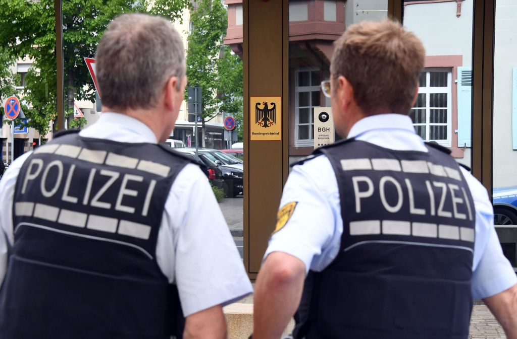 Polizisten stehen vor dem Bundesgerichtshof (BGH) in Karlsruhe, wo die Haftprüfung eines Verdächtigen stattfindet, der im Rahmen der Fahndung nach den Tätern des Anschlags auf den Mannschaftsbus von Borussia Dortmund festgenommen wurde.